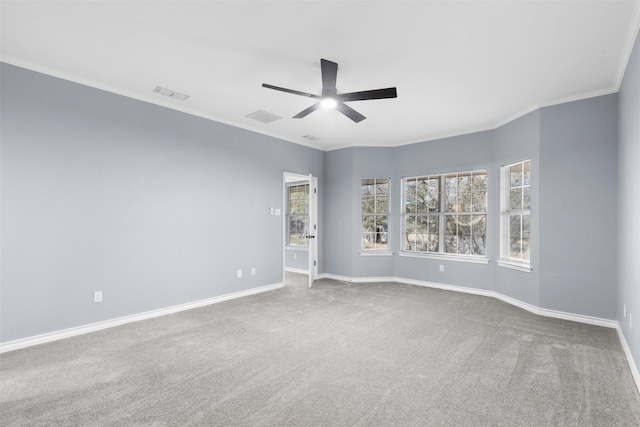 carpeted empty room with ornamental molding and ceiling fan