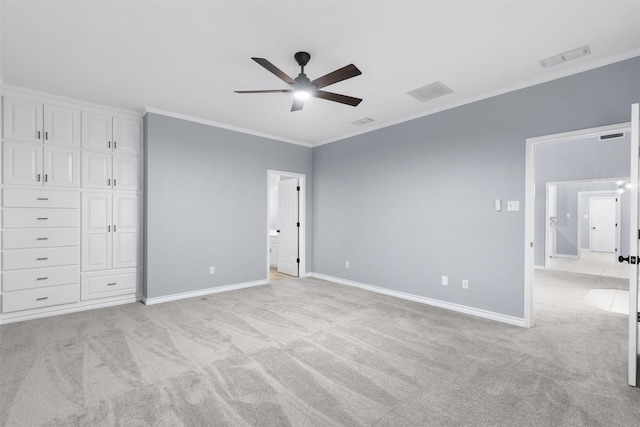 unfurnished bedroom featuring light carpet, ceiling fan, and crown molding