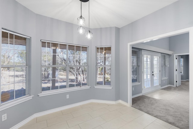 interior space featuring french doors and light colored carpet