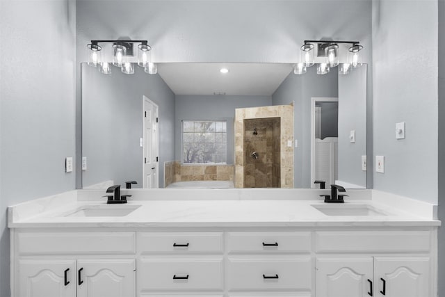 bathroom featuring a tile shower and vanity