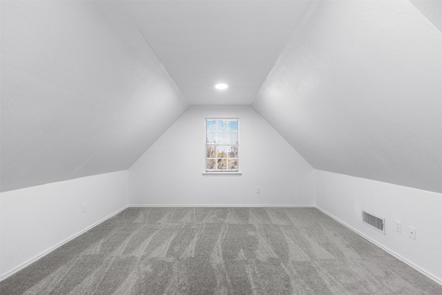 bonus room featuring lofted ceiling and carpet