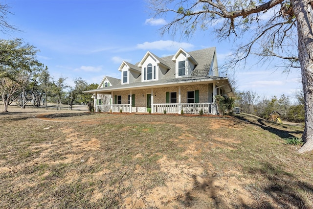 view of front facade with a front yard and a porch