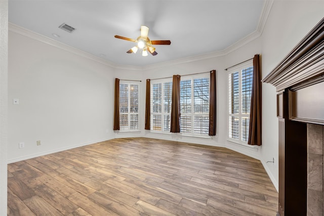 unfurnished room featuring ceiling fan, crown molding, and light hardwood / wood-style flooring