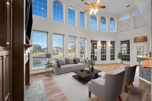 sunroom / solarium featuring ceiling fan