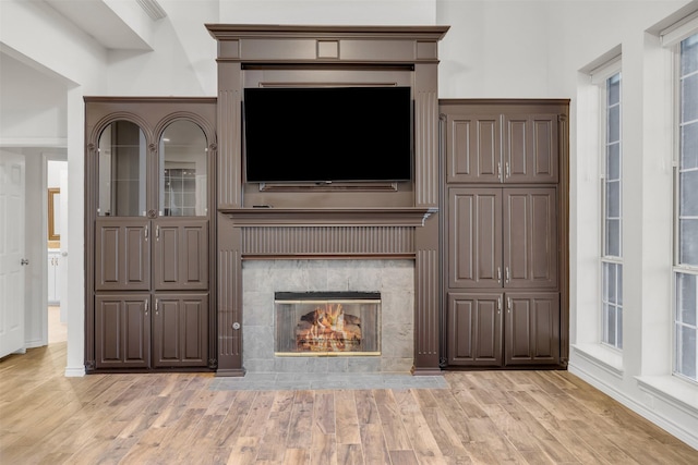 unfurnished living room with light hardwood / wood-style flooring and a fireplace