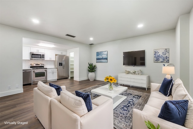 living room with dark hardwood / wood-style flooring