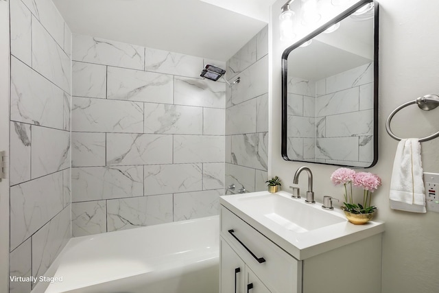 bathroom with tiled shower / bath and vanity