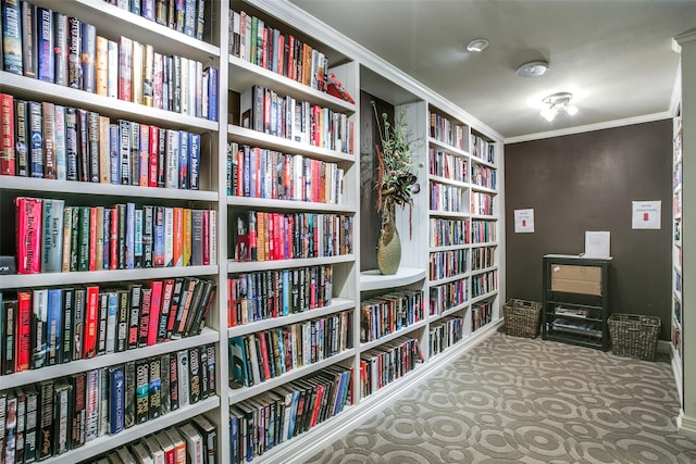 living area with ornamental molding and carpet flooring