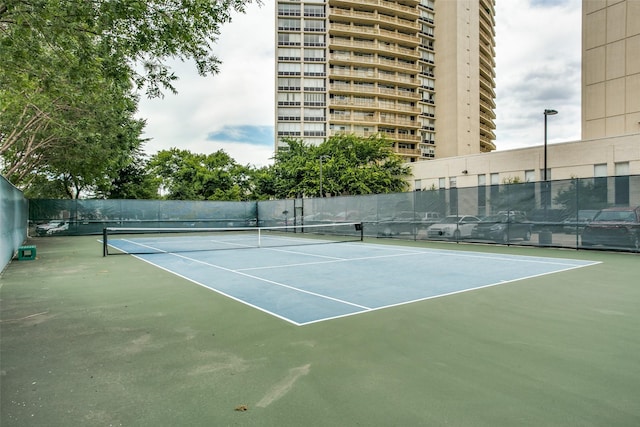 view of tennis court featuring basketball hoop