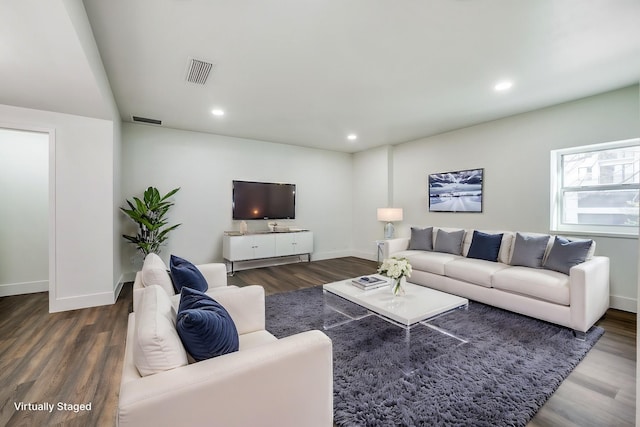 living room with dark hardwood / wood-style flooring