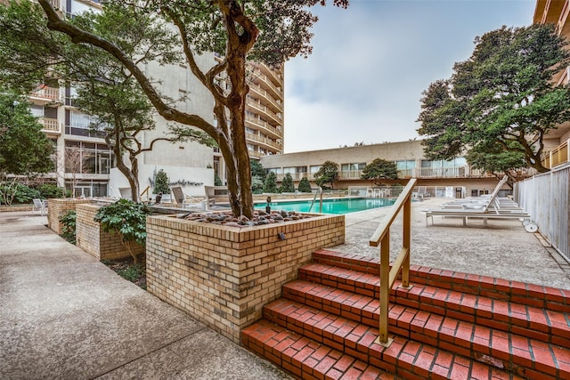 view of swimming pool with exterior kitchen and a patio area