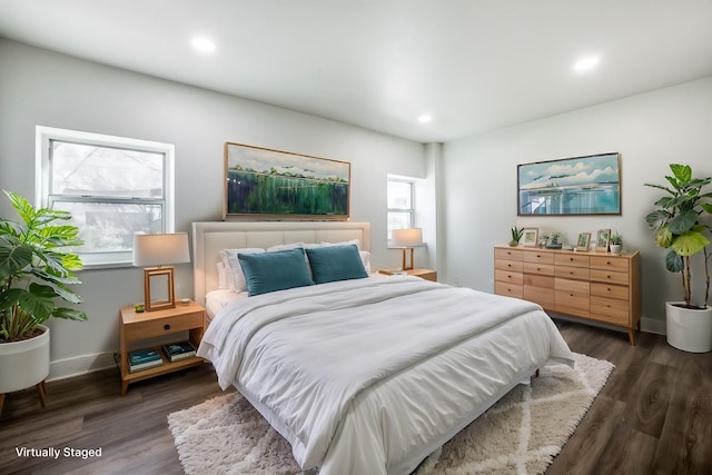 bedroom with dark wood-type flooring