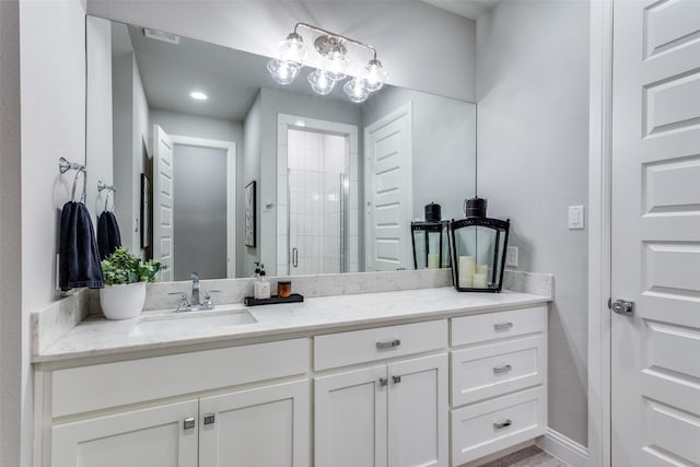 bathroom with vanity and a shower with shower door