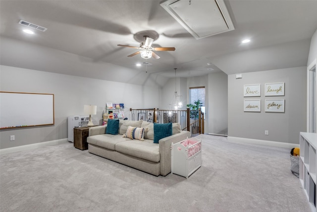 living room with lofted ceiling, ceiling fan, and light carpet