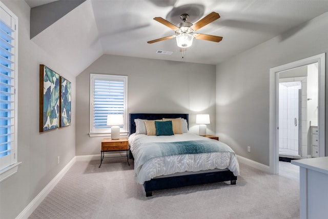 bedroom with lofted ceiling, connected bathroom, ceiling fan, and light colored carpet