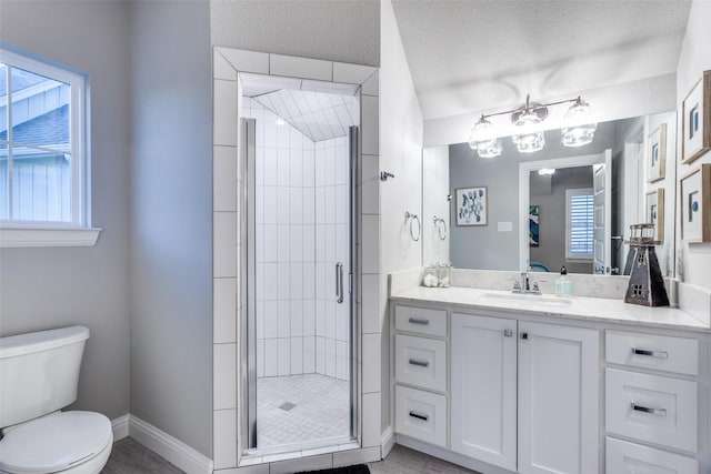 bathroom with a textured ceiling, a shower with door, vanity, and toilet