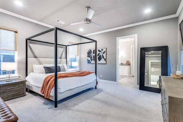 carpeted bedroom featuring ceiling fan, ensuite bathroom, and ornamental molding