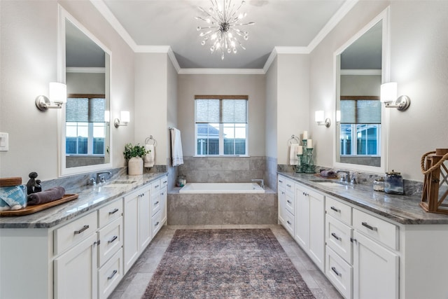 bathroom with ornamental molding, tiled tub, and vanity