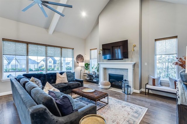 living room with a tile fireplace, high vaulted ceiling, ceiling fan, and dark hardwood / wood-style floors