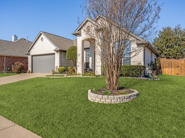 view of front of property featuring a front yard and a garage