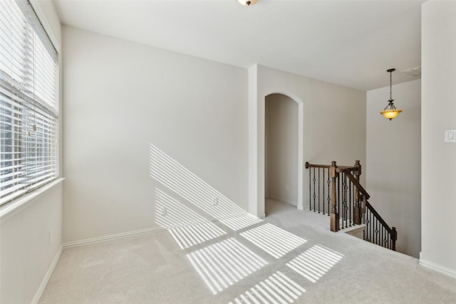 stairs with a healthy amount of sunlight and carpet floors