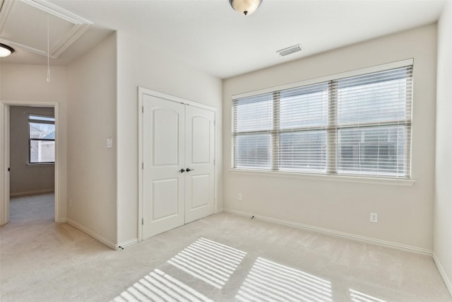 bedroom with light colored carpet and a closet