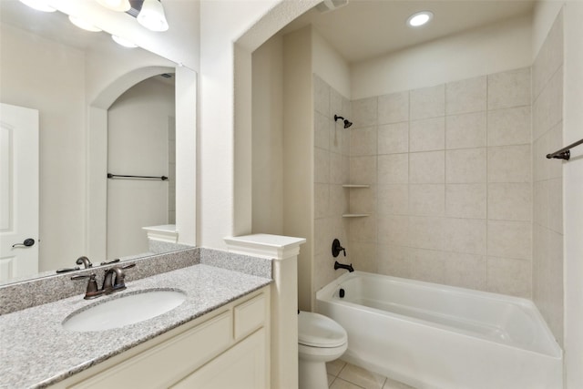 full bathroom featuring vanity, tile patterned floors, tiled shower / bath combo, and toilet