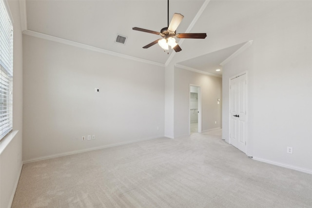 unfurnished room featuring ceiling fan, light carpet, ornamental molding, and a wealth of natural light