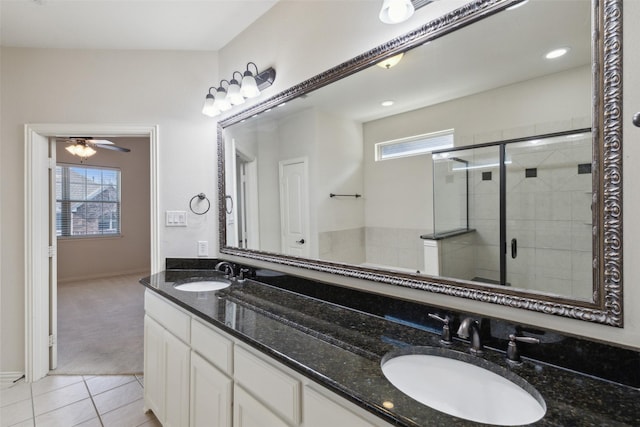 bathroom with vanity, walk in shower, ceiling fan, and a wealth of natural light