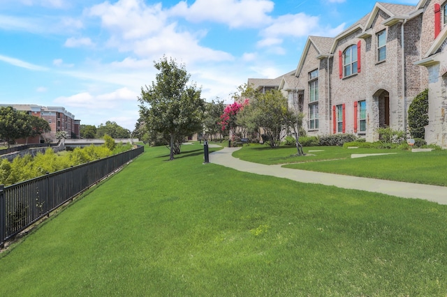 view of home's community with a lawn