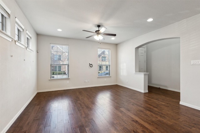 spare room with dark wood-type flooring and ceiling fan