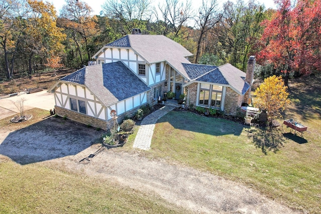 tudor home with a front lawn