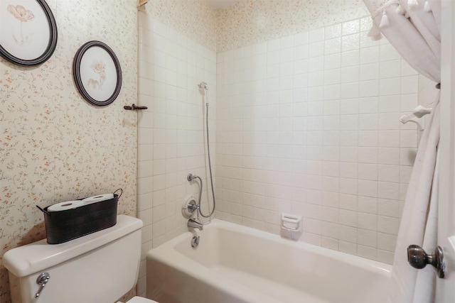 bathroom featuring toilet and tiled shower / bath combo