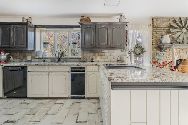 kitchen featuring dishwasher, dark brown cabinets, sink, cream cabinets, and backsplash