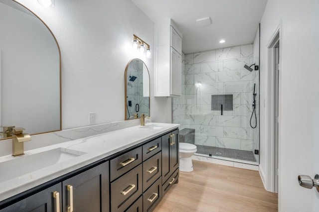 bathroom featuring toilet, wood-type flooring, vanity, and an enclosed shower