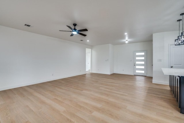 unfurnished living room with light wood-type flooring and ceiling fan