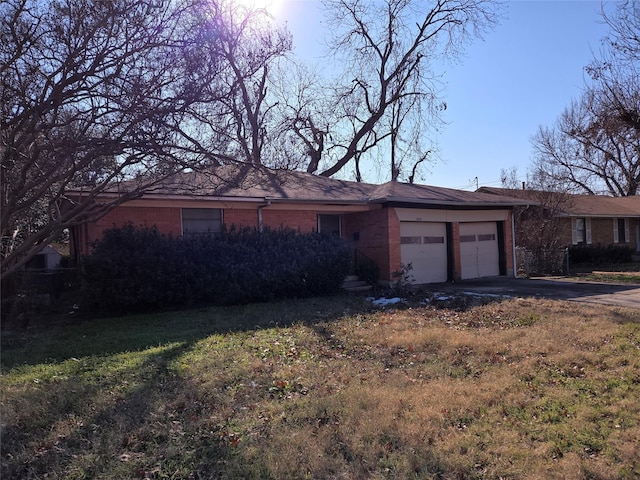 ranch-style home with a garage and a front yard