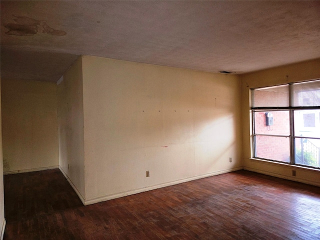 spare room featuring dark hardwood / wood-style flooring