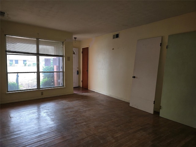 spare room with dark wood-type flooring