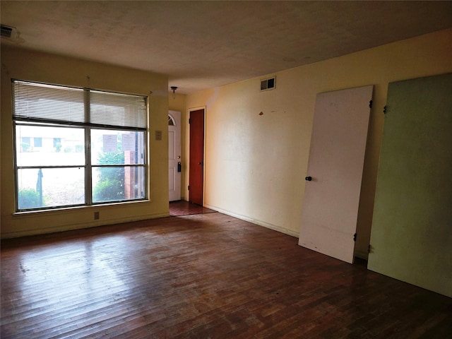 empty room featuring dark wood-type flooring