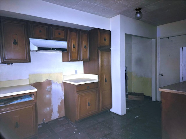 kitchen featuring dark brown cabinets and exhaust hood