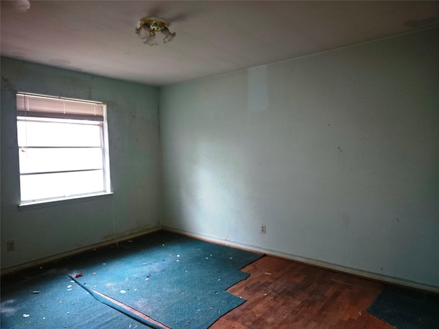 spare room with dark hardwood / wood-style floors