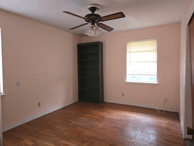 spare room with hardwood / wood-style floors and ceiling fan