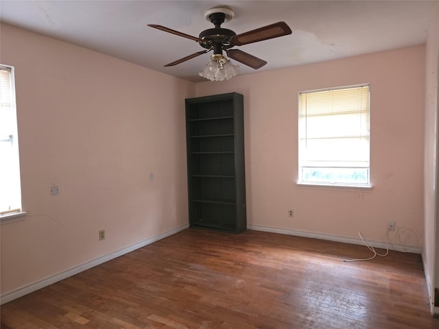 spare room with hardwood / wood-style floors and ceiling fan