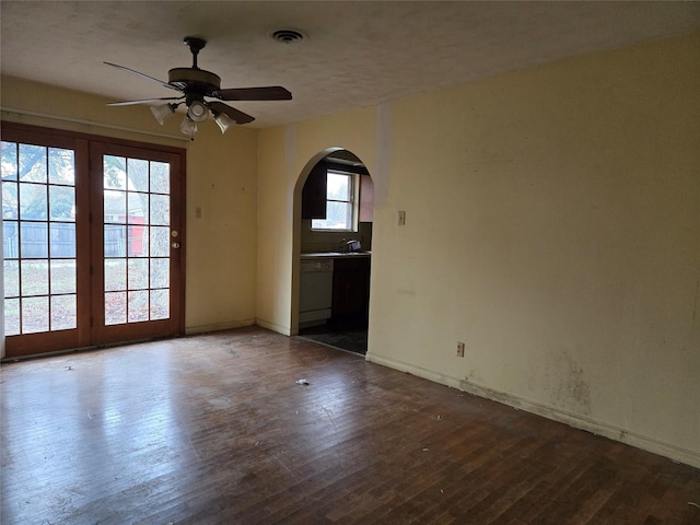 empty room with ceiling fan and dark hardwood / wood-style floors