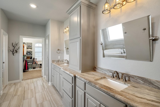 bathroom with a tub to relax in and vanity