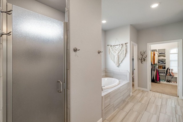 bathroom featuring separate shower and tub