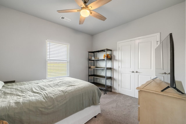 carpeted bedroom with a closet and ceiling fan