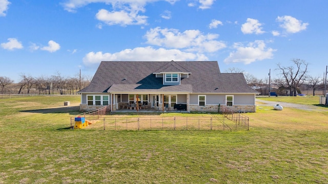 rear view of property featuring a lawn