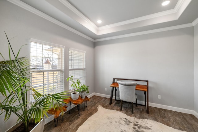 office space with ornamental molding, dark wood-type flooring, and a tray ceiling